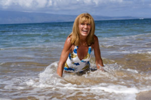 Woman in a floral swimsuit enjoying the ocean waves.